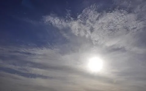 Cirrostratus clouds begin to gradually cover the solar disk in the sky. Signs Stock Photos