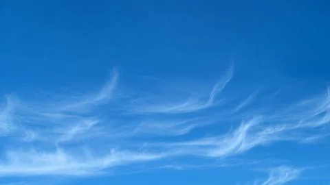 Cirrus cloud floating in clear blue sky, copy space. Wispy meteorological for Stock Photos