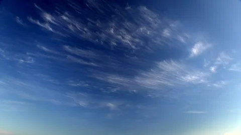 Cirrus clouds drift across blue sky in timelapse - Wispy Clouds and High Cloud Stock Footage 339489267