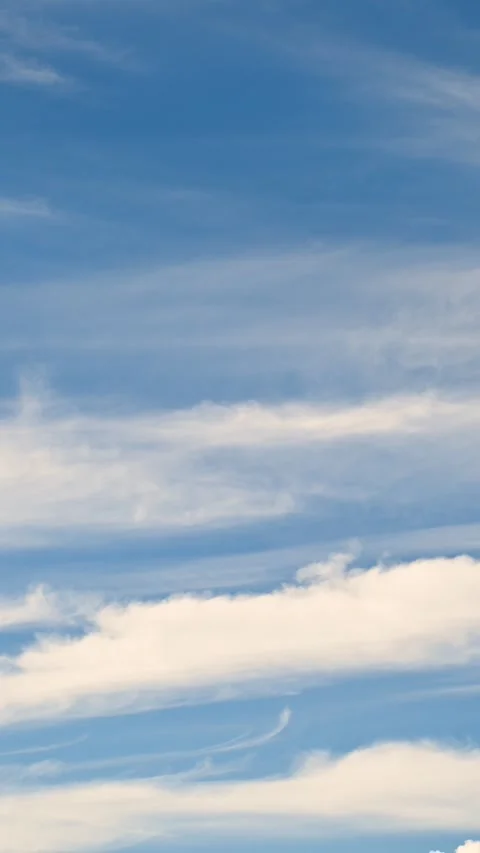 Cirrus clouds drifting across clear blue sky during daytime Stock Footage 331222025