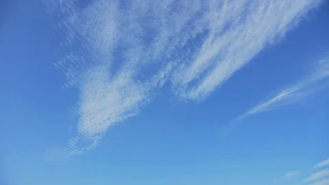 Cirrus clouds float in the clear blue sky Stock Footage 123603752