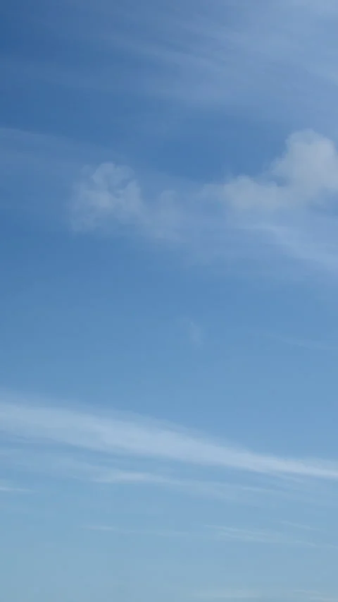Cirrus clouds slowly drift through the serene blue sky in timelapse video. Stock Footage 240650792