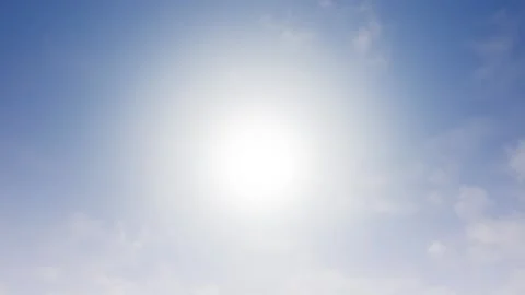 Cirrus clouds slowly roll over the camera and hide the burning sun. Stock Footage 147169837