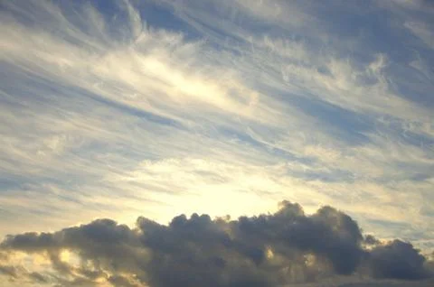 Cirrus clouds in the sunset sky. Cloudscape. Stock Photos