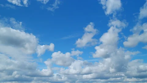 Cirrus or feather and cumulus on different layers clouds against a blue sky Stock Footage 216371367
