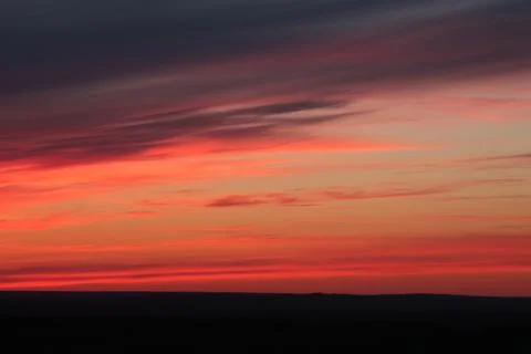 Cirrus red clouds during sunset Stock Photos