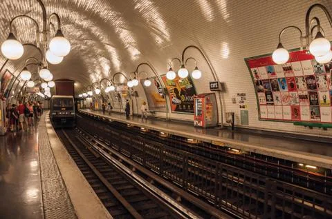 Cite subway station platform with train and luminaires in Paris Photos