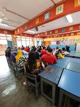 Citizen queuing for voting at a school in a classroom. Stock Photos