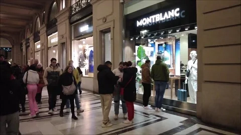 Citizens and tourists stroll in front of a Montblanc store 스톡 동영상 296493641
