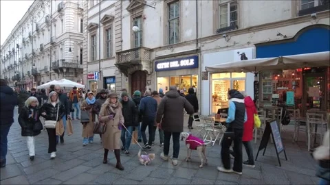Citizens and tourists walking down a shopping street in the old town Stock Footage 296069170