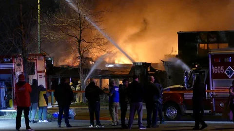 Citizens can't help but gather to watch unfolding fire despite covid-19 Stock Footage 129987401