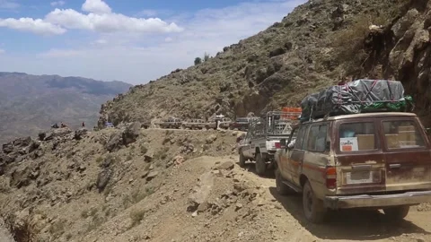 Citizens transport their needs on bumpy roads because of in the city of Taiz Stock Footage 160288604