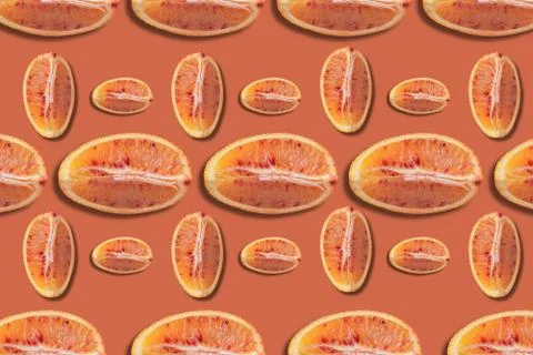 Citrus background, pattern of red orange slices on orange background Stock Photos