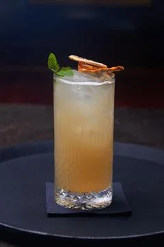 Citrus cocktail decorated with mint on a dark table Stock Photos