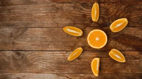 Citrus composition, orange in the shape of sun on the wooden background. Stock Photos