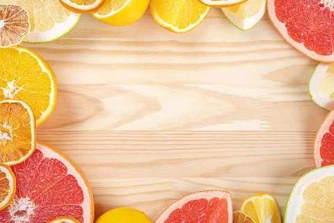 Citrus frame template on wood table. Different sliced juicy citrus fruits. fr Stock Photos