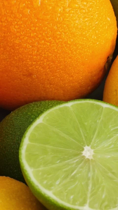 Citrus fruit background, a lot of lemon, oranges and limes.  Vertical Stock Footage 301741393