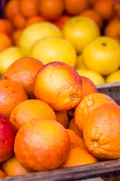 Citrus fruit in boxes, selective focus, blurred background. Stock Photos