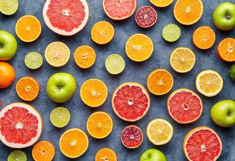 Citrus fruit pattern on grey concrete table. Fruit food background. Healthy Stock Photos
