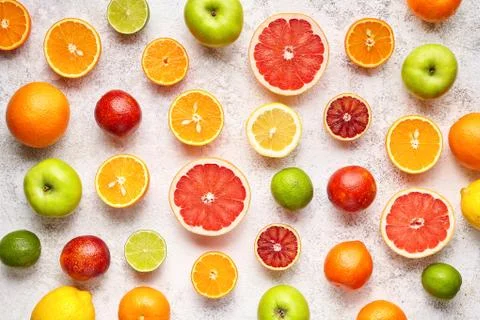 Citrus fruit pattern on white concrete table. Food background. Healthy eating Stock Photos