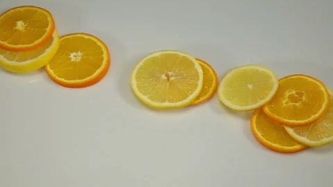 Citrus Fruit Slices Falling on the White Surface. Stock Footage 71967635