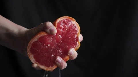 Citrus fruit - squeezing a grapefruit by hand Stock Footage 158968988