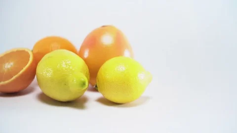 Citrus fruit on white background, sliding, shallow Depth of field Video stock 75819355