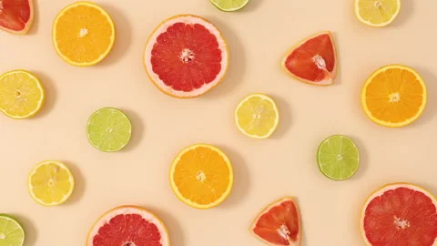 Citrus fruits make creative pattern on sandy background. Stop motion flat lay Stock Footage 152492732