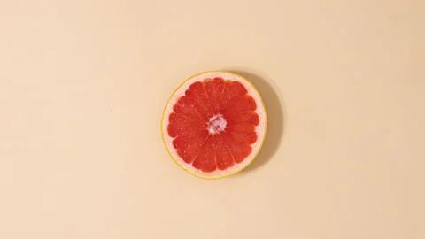 Citrus grapefruit rotating on beige background. Stop motion 스톡 동영상 152896212