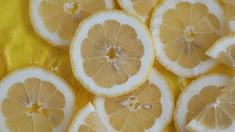 Citrus lemon slices on yellow background moving in water with ripples Stock Footage 155706293
