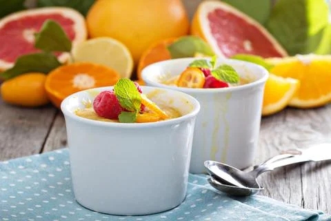 Citrus pudding in white ramekins Stock Photos