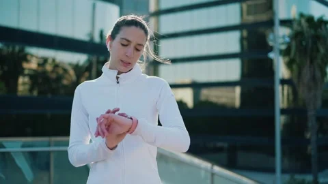 City athlete tracks progress with smart watch and earbuds Stock Footage 254686385