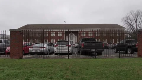 City of Augusta utility and waterworks building and gate parked trucks Stock Footage