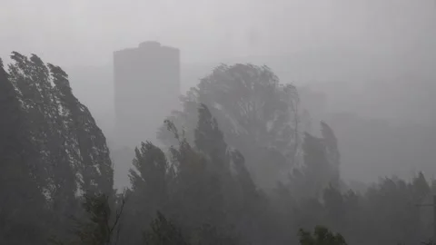 City battered by strong winds and torrential rain during a spring storm Stock Footage 140404575