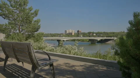City bench looking out at river and bridge Stock Footage 211878914