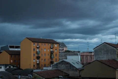 City buildings underneath dramatic sky Stock Photos