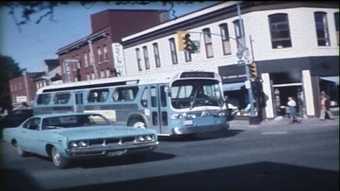 City bus makes left turns at intersection in downtown of a small city. Video stock 85352987