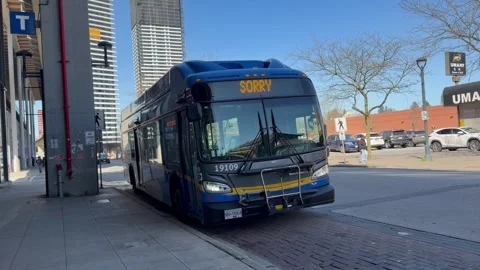 City Bus Parked at Bus Loop Station Displaying Not In Service LED Sign 4K Stock Footage 332930220