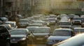 City cars vehicles lined traffic jam, dusk sun rays, movement HD Footage