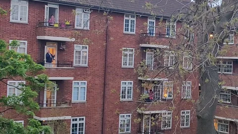 CITY CLAPPING FOR NURSES AND ESSENTIAL WORKERS COVID19 LOCKDOWN LONDON Stock Footage 128543936