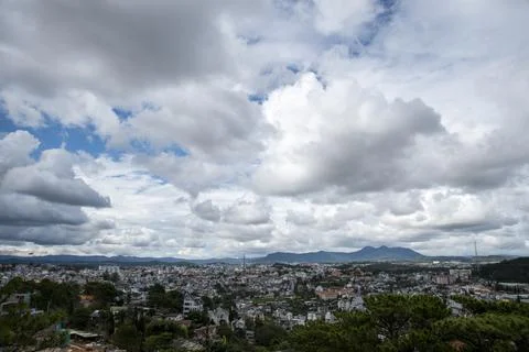 A city with a cloudy sky in the background Stock Photos