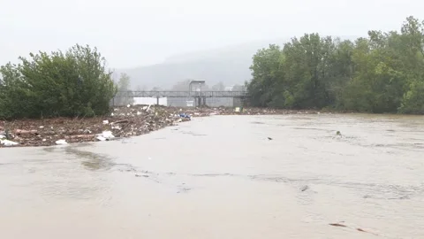 City dam to hold the river level during flooding after heavy rains, Video stock 284737652