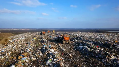 City Dump. The Bulldozer Compacts the Garbage on the Landfill. Wastes of Human Stock Footage 87306222