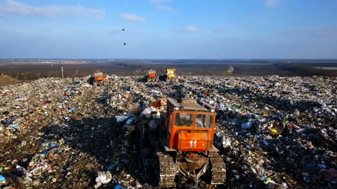 City Dump. The Bulldozer Compacts the Garbage on the Landfill. Wastes of Human Stock Footage 87306874