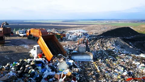 City Dump. The Bulldozer Compacts the Garbage on the Landfill. Wastes of Human Stock Footage 87307452