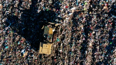 City Dump. The Bulldozer Compacts the Garbage on the Landfill. Wastes of Human Stock Footage 151347345