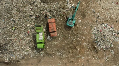 City dump, excavator compacts the garbage on the Landfill, aerial view top down. Stock-Footage 107867476