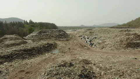 City dump, People are sorting garbage at the job site, aerial view. Stock Footage 107867112