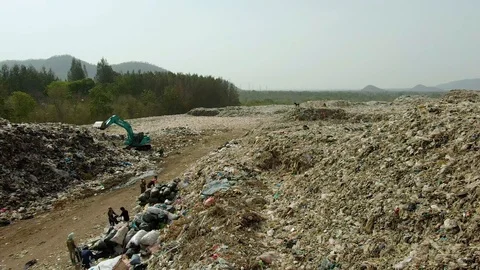 City dump, People are sorting garbage at the job site, aerial view. Stock Footage 107867169