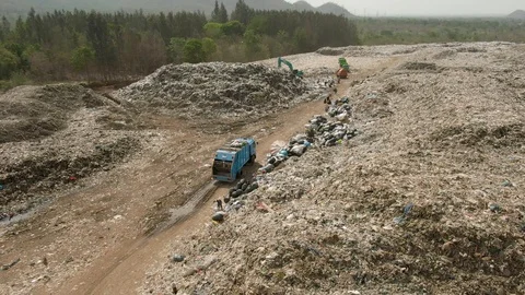 City dump, People are sorting garbage at the job site, aerial view. Stock Footage 107867324